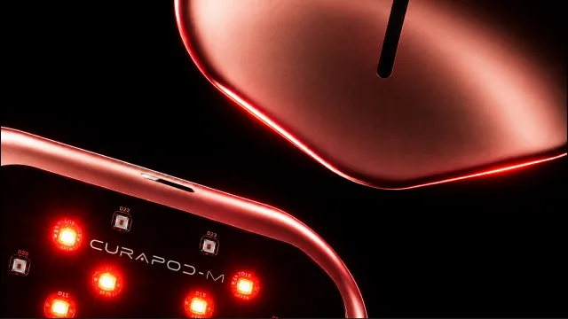 Close-up of the Curapod-M LED side, with glowing red LEDs and the CURAPOD-M name.