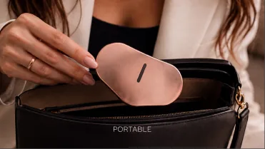 A hand putting the device into a handbag.
